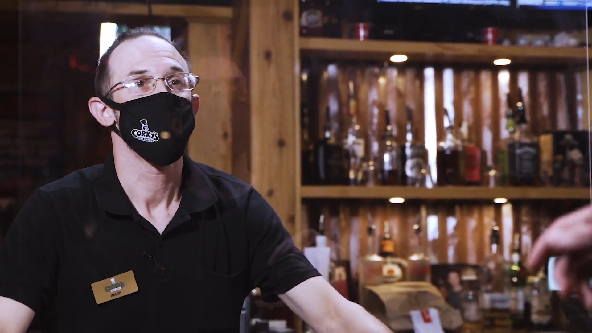Restaurant staff member interviewed behind a bar for a hospitality video
